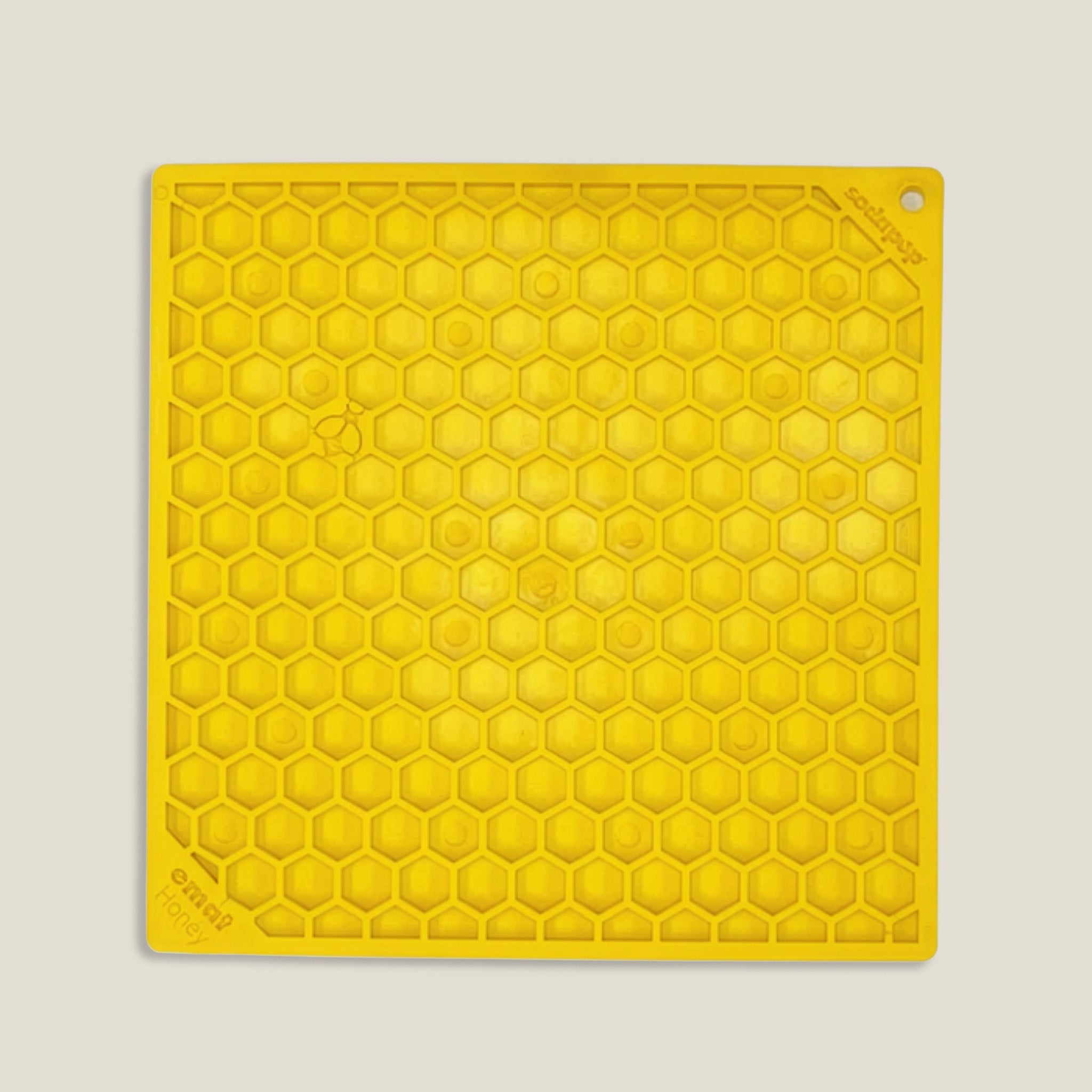 Yellow hexagonal pattern mat on a light beige background