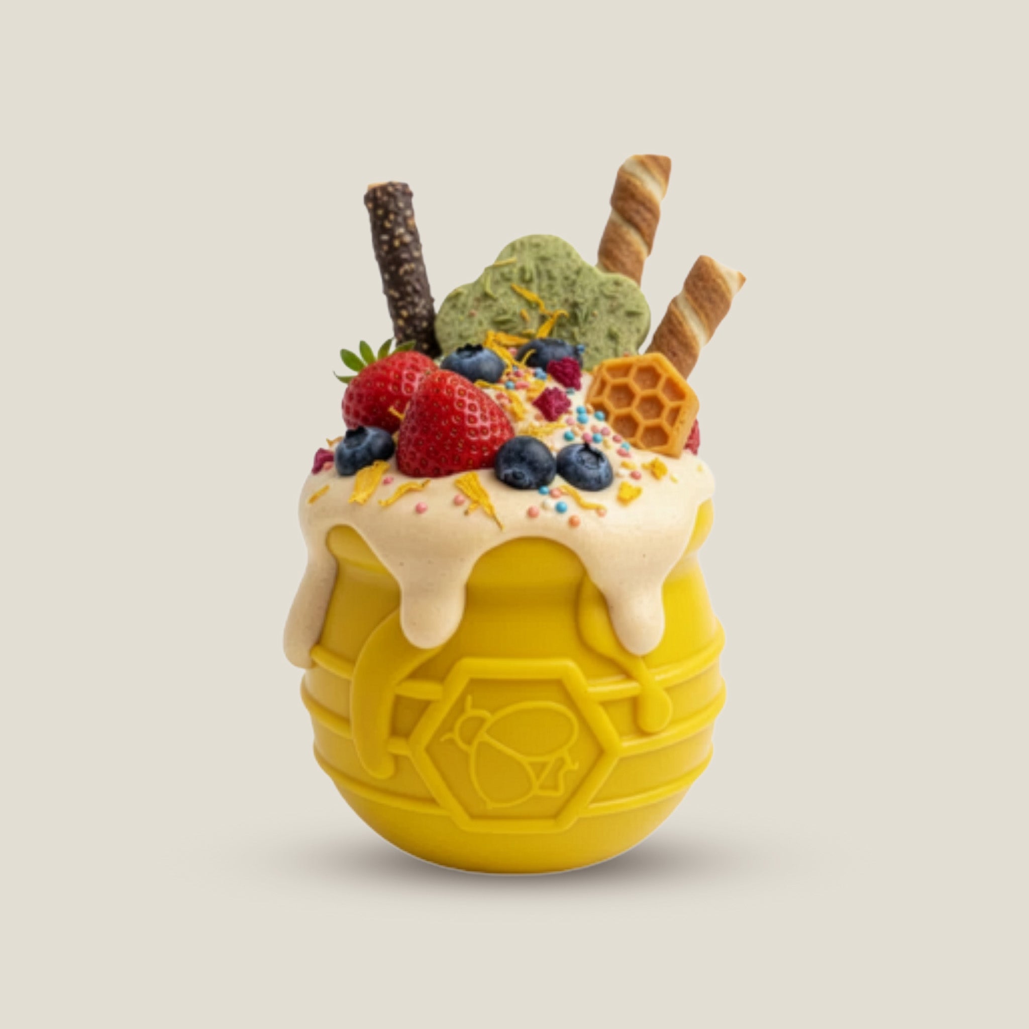Yellow dog honey pot toy with ice cream and toppings on a beige background