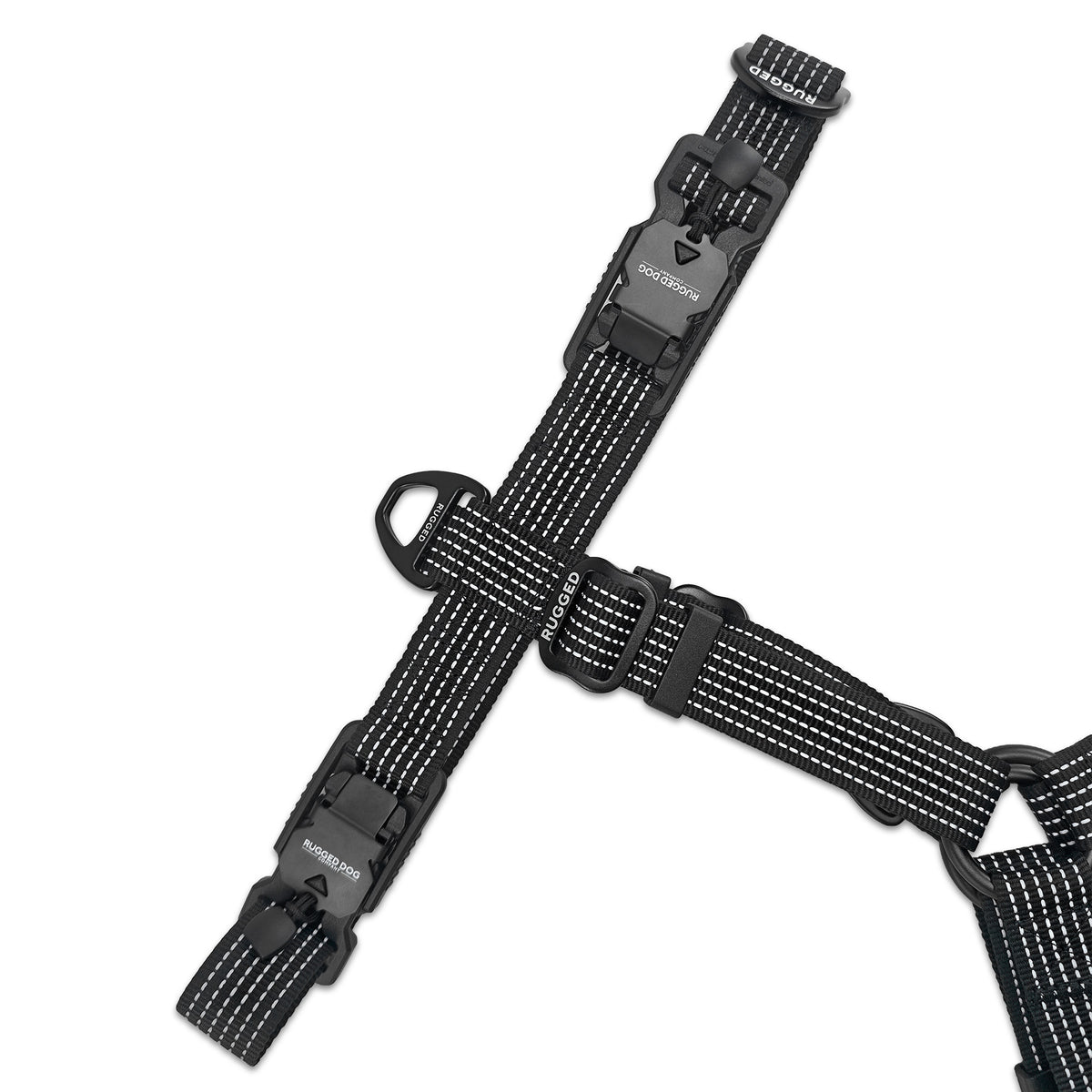 Underside of black Rugged Dog Company no-pull harness showing dual magnetic FIDLOCK V-Buckles, adjustable sternum strap, aircraft-grade aluminum front D-ring, branded metal sliders and high-visibility reflective polyester webbing