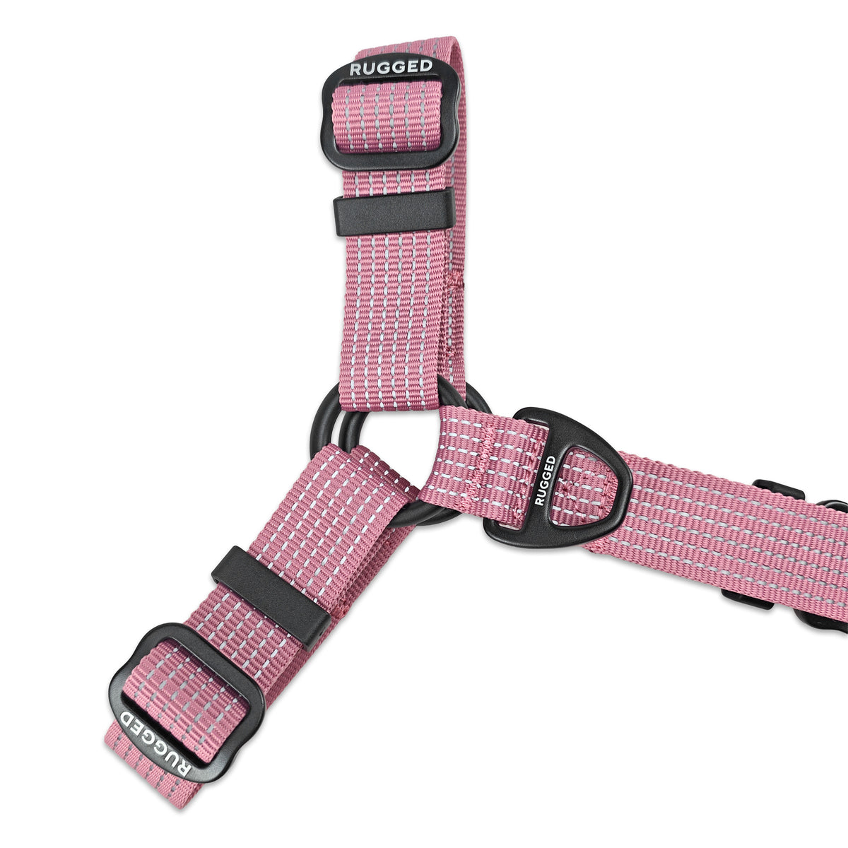 Close-up of Dusty Rose Rugged Dog Company no-pull harness showing reinforced O-ring connection, aircraft-grade aluminum sternum D-ring for front leash attachment and added walking control, adjustable polyester webbing, Rugged-branded metal sliders and high-visibility reflective stitching