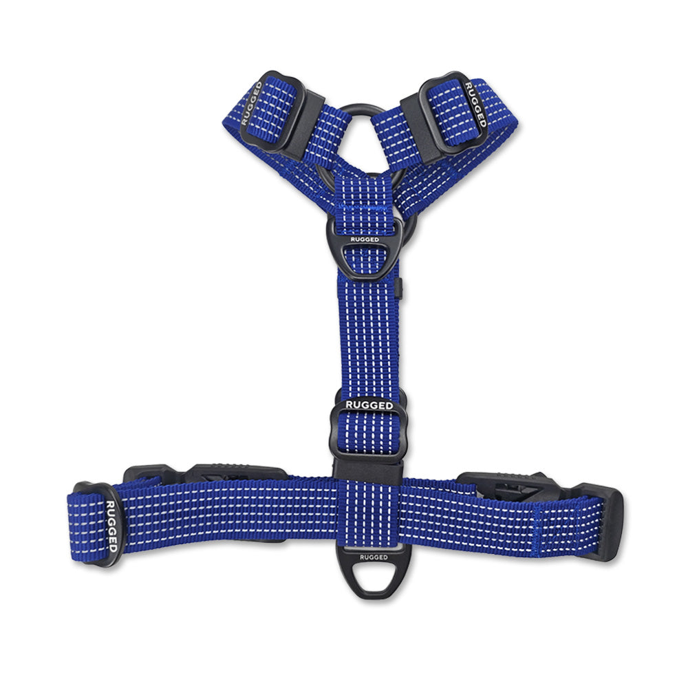 Underside view of Navy Rugged Dog Company no-pull harness showing adjustable sternum strap, large aircraft-grade aluminum front D-ring for added leash control, flexible polyester webbing, Rugged-branded metal adjustment sliders and high-visibility reflective stitching