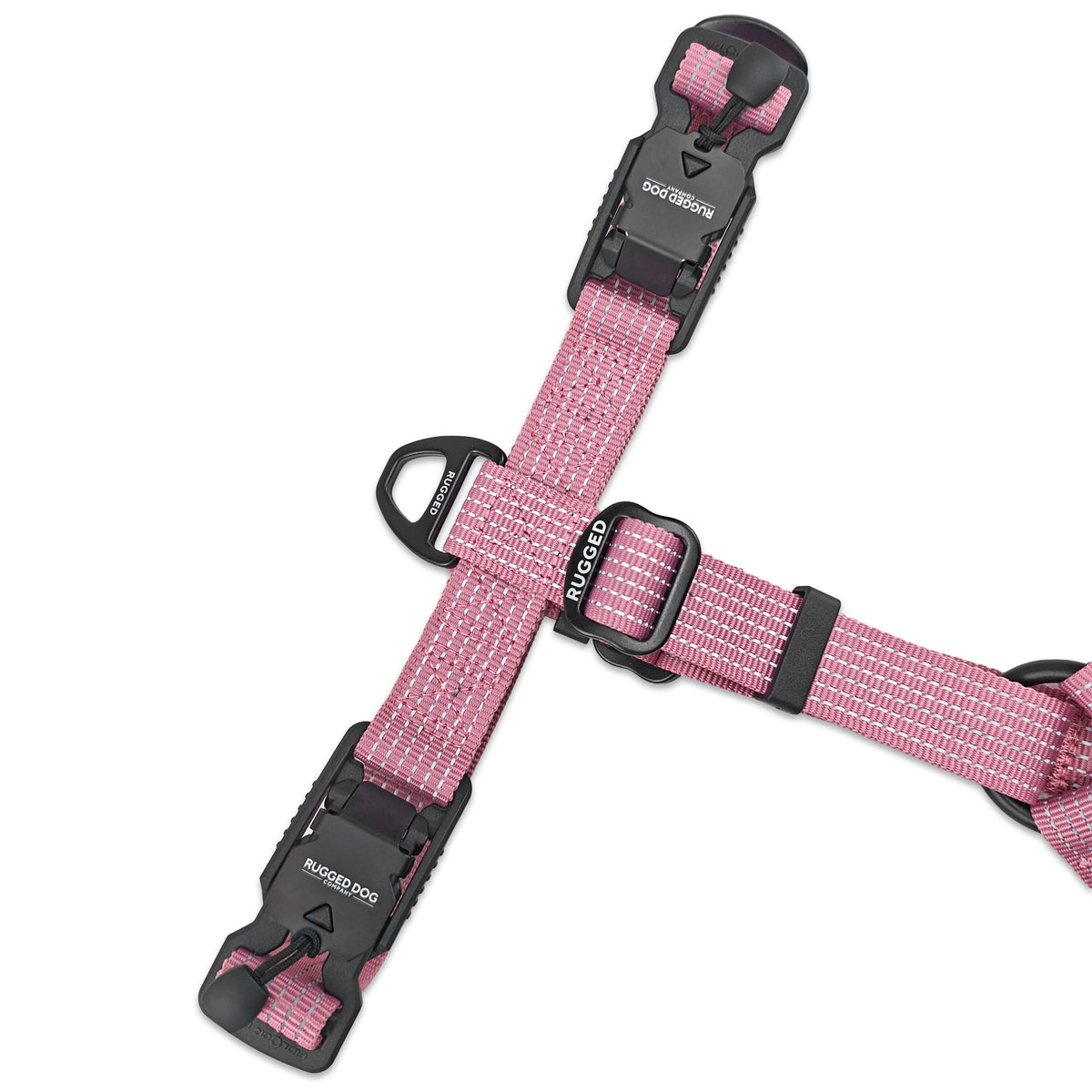 Close-up top view of Dusty Rose Rugged Dog Company no-pull harness showing dual magnetic FIDLOCK V-Buckles, large aircraft-grade aluminum back D-ring for leash attachment, Rugged-branded metal adjustment sliders and high-visibility reflective polyester webbing